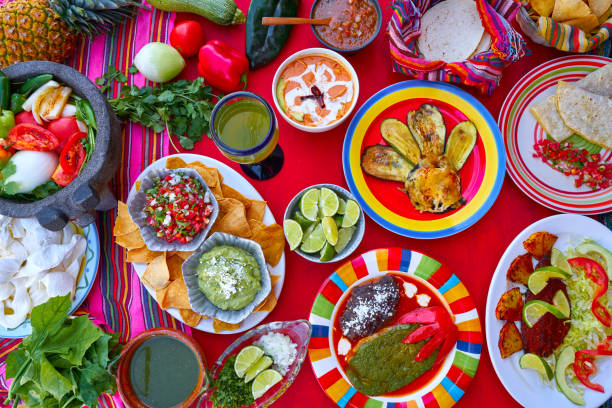 Mexican recipes mix on a colorful table with sauces from Mexico